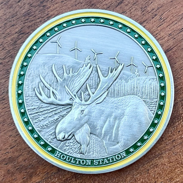 Round silver challenge coin belonging to Houlton Station in Houlton, Maine. 