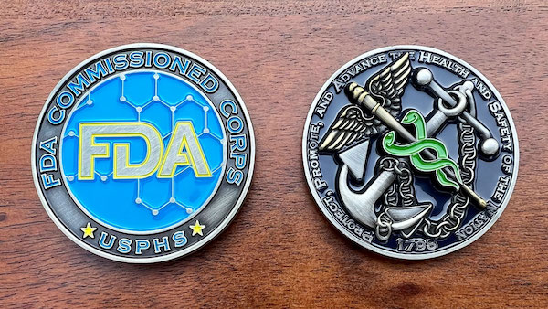 Round antique silver challenge coin representing the FDA. 