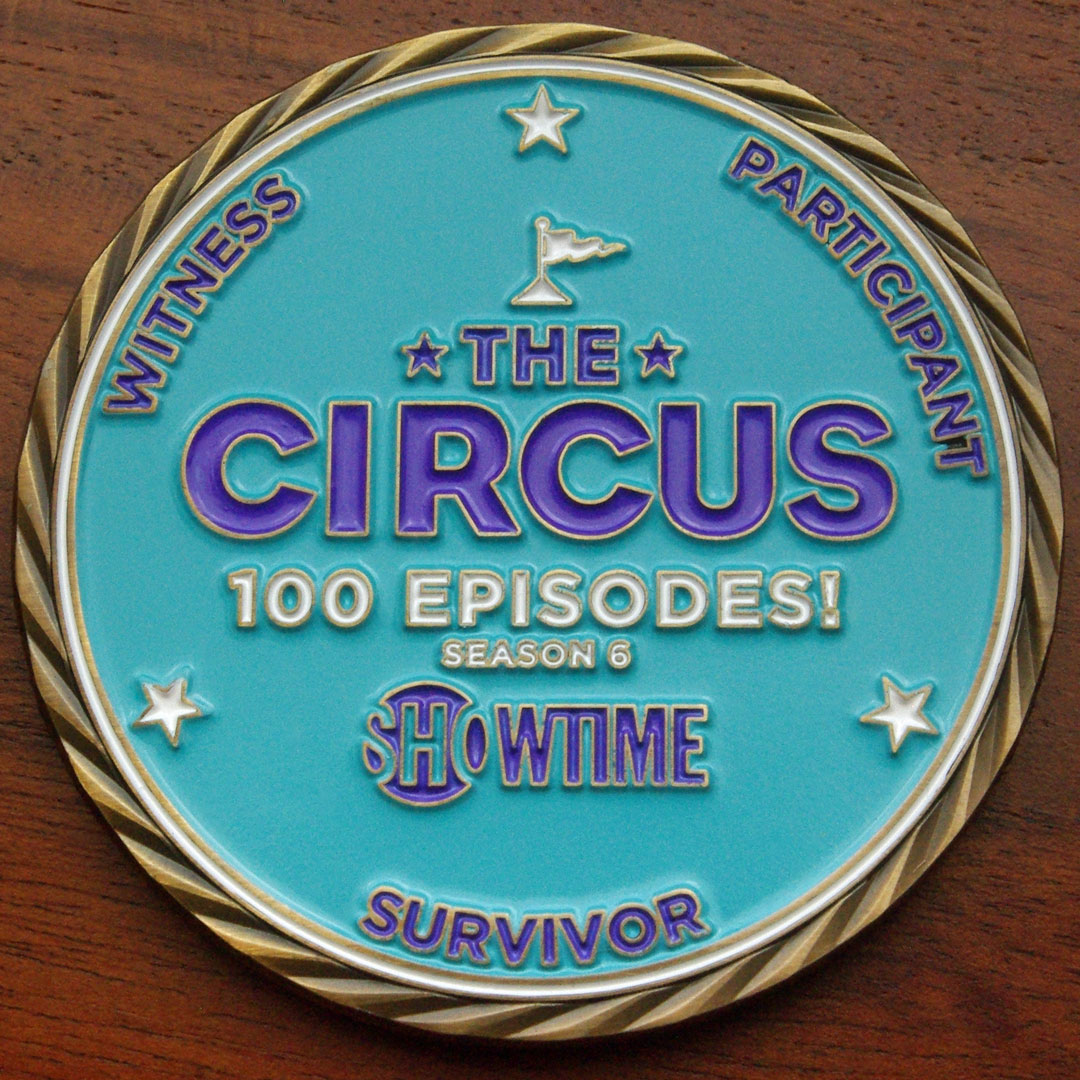 Round gold challenge coin representing Showtime's "The Circus." 