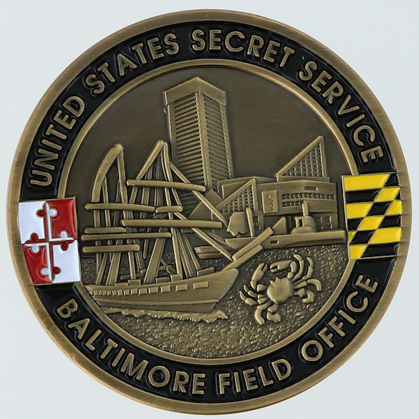 Front side of a round challenge coin belonging to the United States Sercret Service's Baltimore Field Office. 