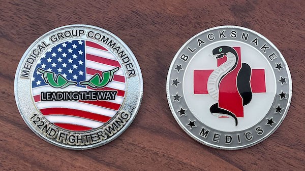 Front and reverse side of a polished silver challenge coin for the 122nd Fighter Wing Medical Group Commander. 