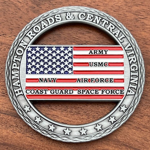 Antique silver coin with U.S. flag in the center with names of all 6 U.S. military branches. Cutouts above and below flag.