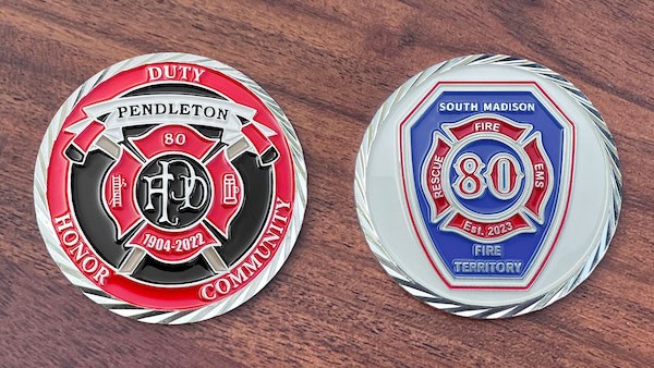 Front and reverse side of a polished silver challenge coin belonging to the Pendleton (Indiana) Fire Department. 