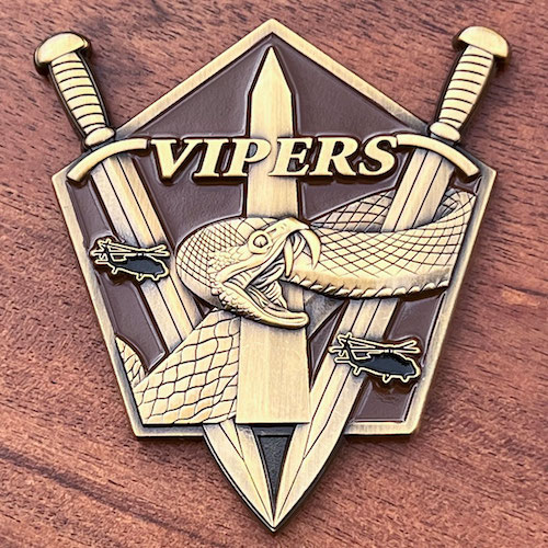 Pentagon-shaped custom coin with two swords that meet at a point at the bottom, a center obelisk, a snake and two helicopters. The word Viper at top center