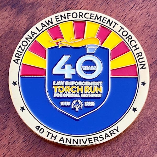 Round gold challenge coin for Arizona Law Enforcement Torch Run 40th anniversary. 